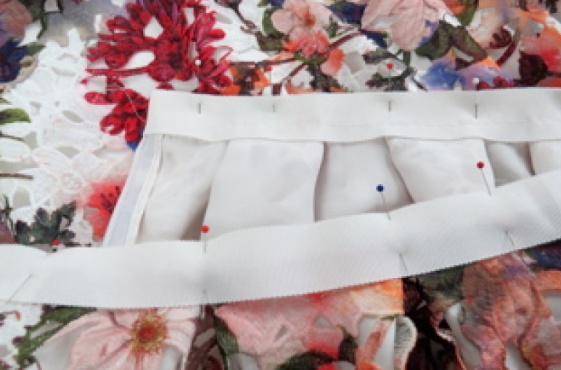 Pin the second layer of Petersham to the outside of the skirt, aligning the top edges of the waistband.